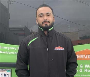 Adrian standing in front of Servpro truck