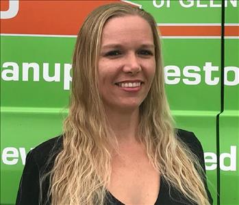 Woman in black shirt in front of green background