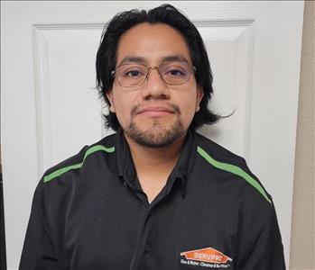 Man in black shirt, white door behind