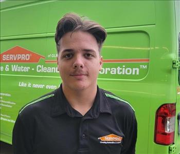 man in black shirt, in front of servpro truck 